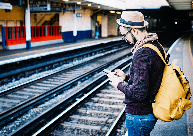 Man at Railway Station Typing on Phone Man at Railway Station Typing on Phone